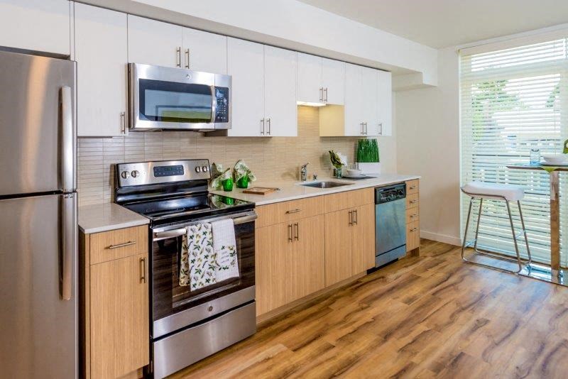 a kitchen with stainless steel appliances and white cabinets