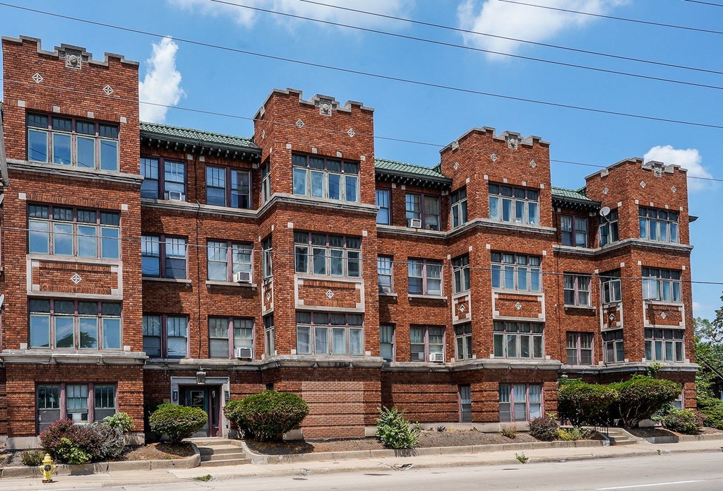 a large brick apartment building on a city street