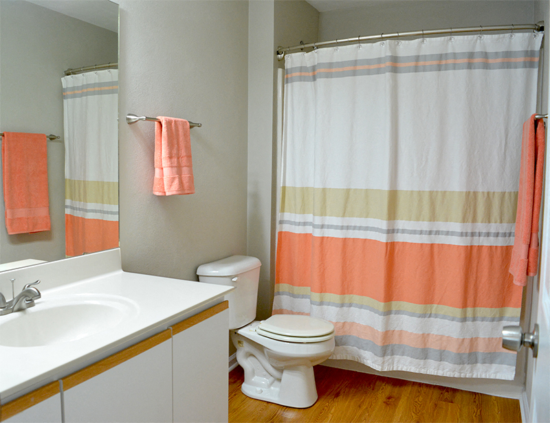 Bathroom with single vanity, toilet, and full bath