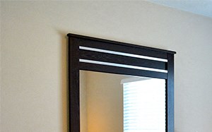 Bedroom with plenty of natural light, queen size bed, dresser and mirror