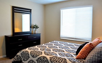 Bedroom with plenty of natural light, queen size bed, dresser and mirror - Photo Gallery 18