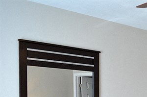 Bedroom with queen size bed, dresser, mirror, and walk-in closet