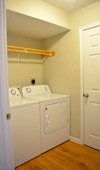 In-unit laundry room with full-size washer and dryer and hanging rack - Photo Gallery 20