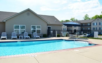 Outdoor pool located next to the clubhouse with lounge chair seating - Photo Gallery 13