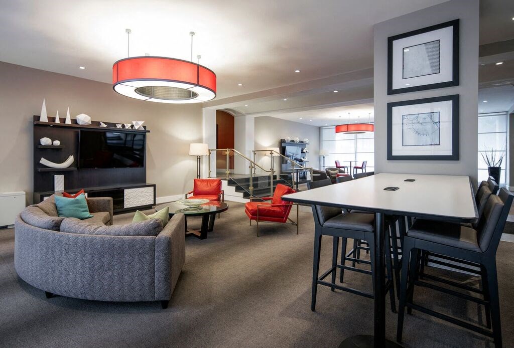 a living room and dining room with a table and chairs