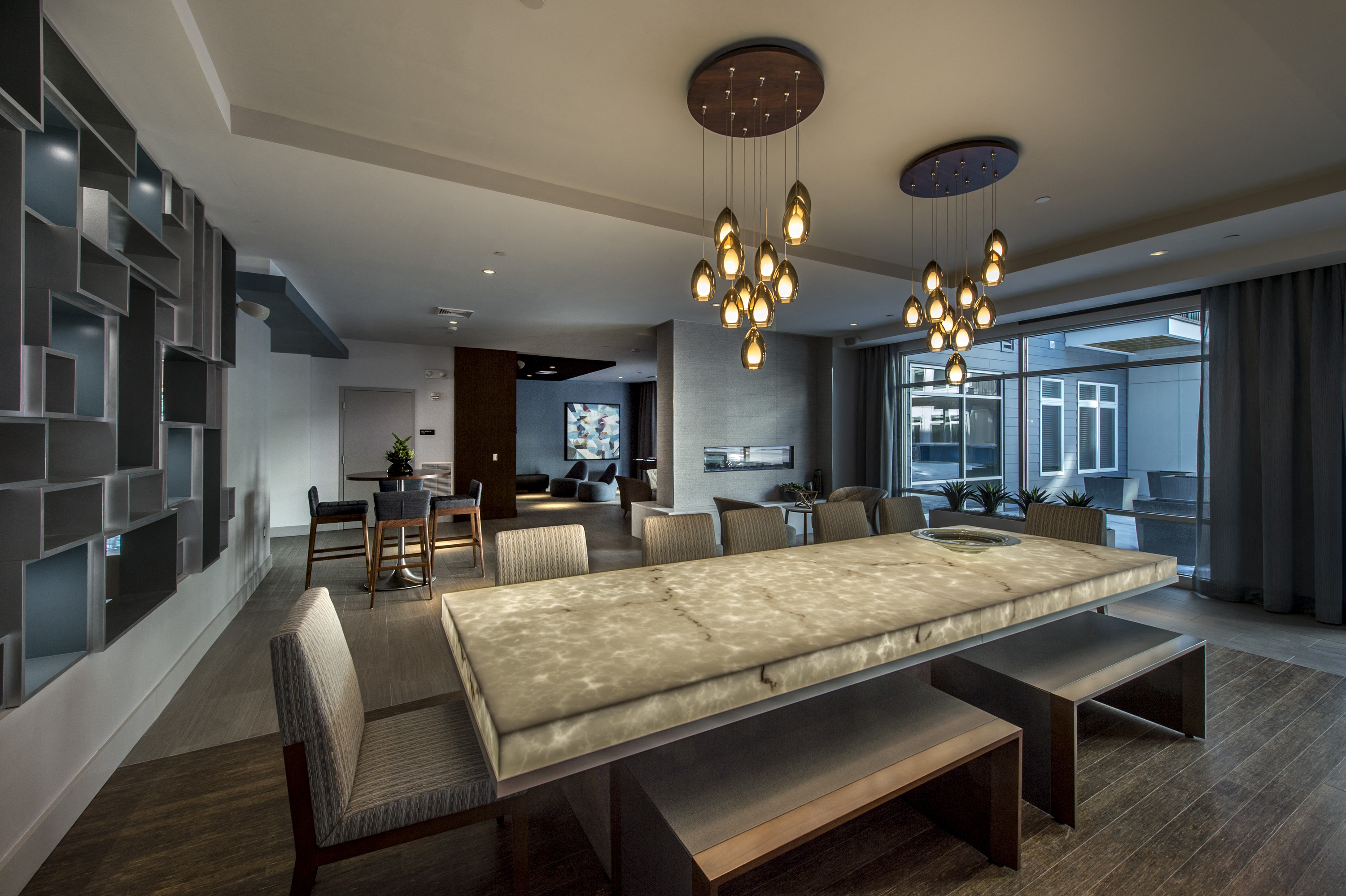 a dining room and living room with a large table and chairs
