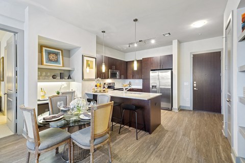 a kitchen and dining room with a table and chairs