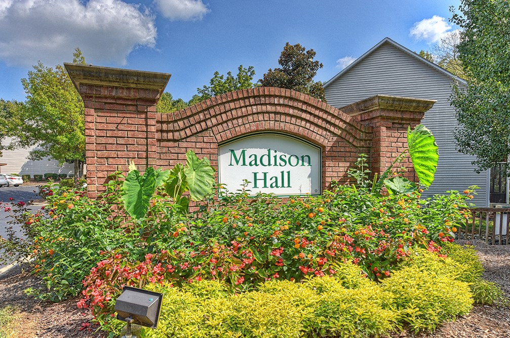 the sign is in front of a brick wall