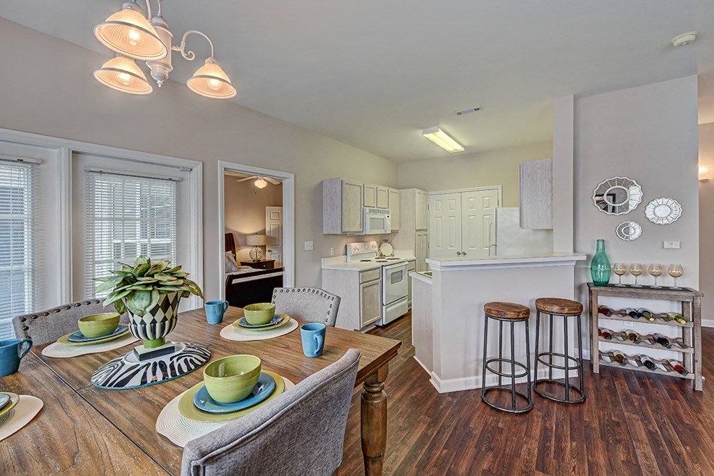 a kitchen and dining room with a table and chairs