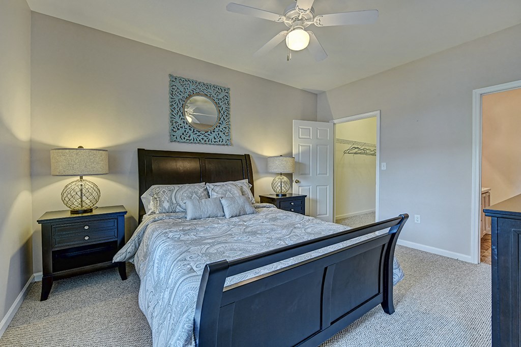 a bedroom with a large bed and a ceiling fan