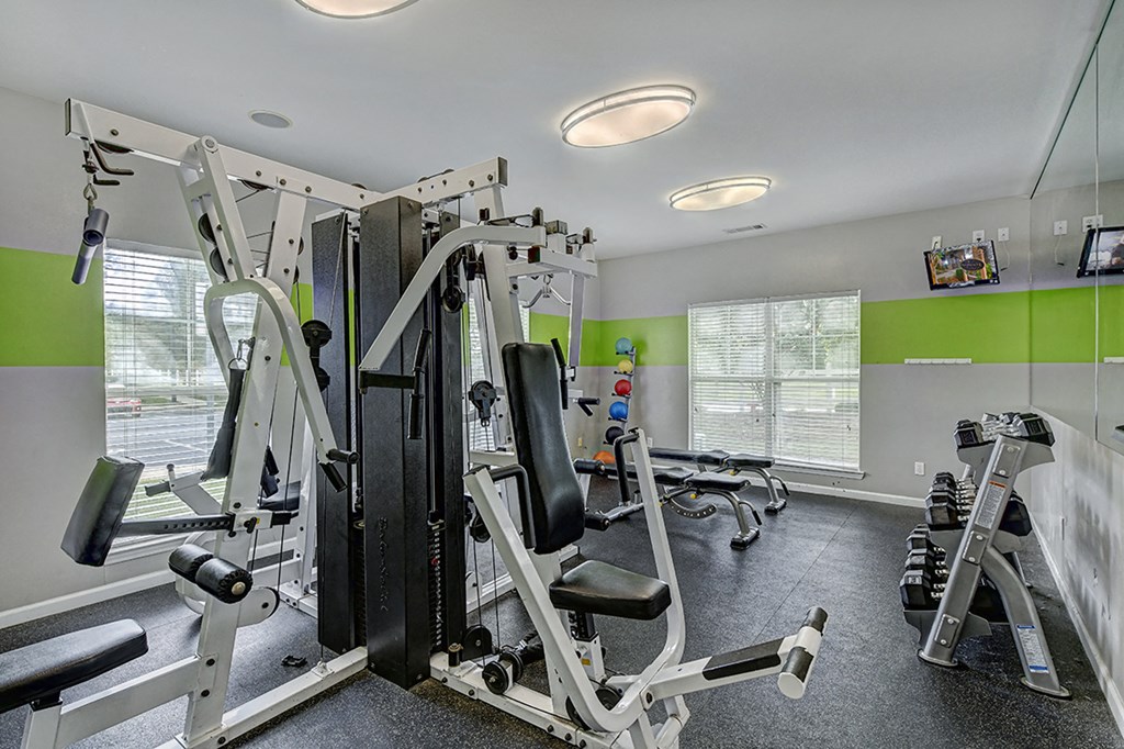 a gym with weights and cardio equipment in a home for sale