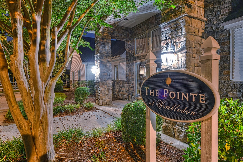 a sign for the pointe at universal citywalk in front of a stone building