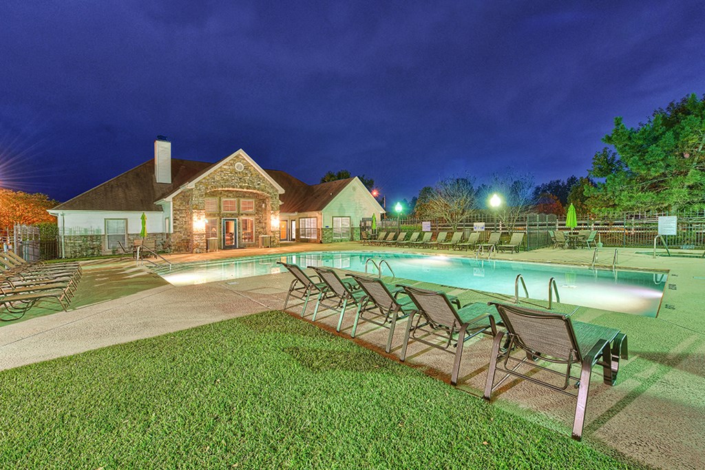the pool is lit up at night at our apartments