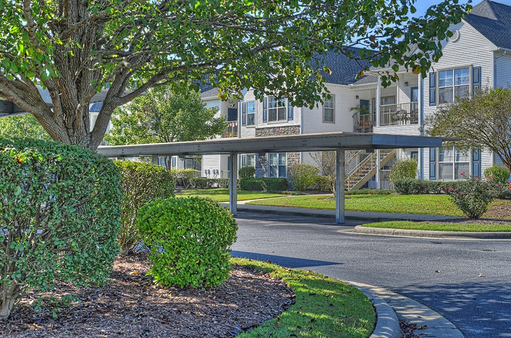 a covered walkway in front of an apartment building