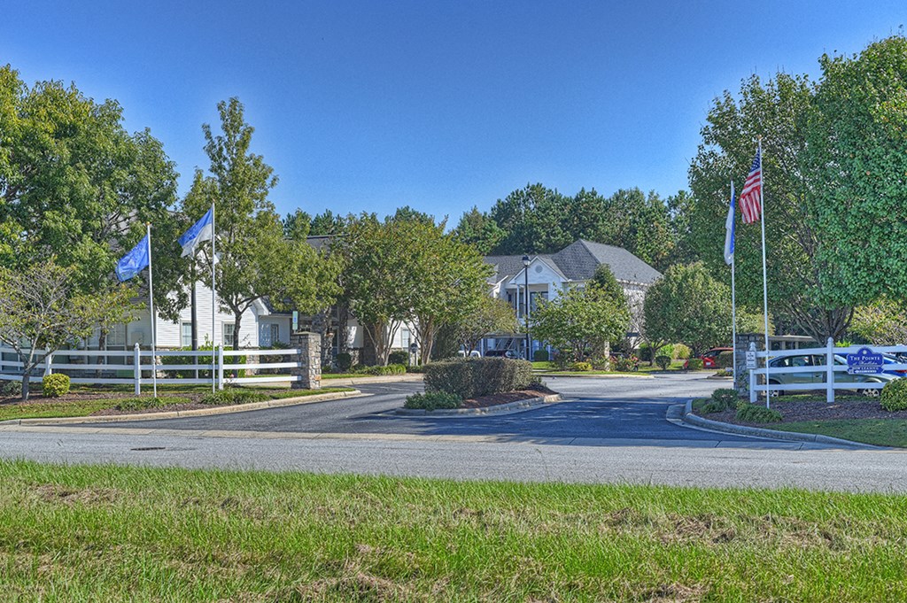 a street with flags and houses on the side of a road