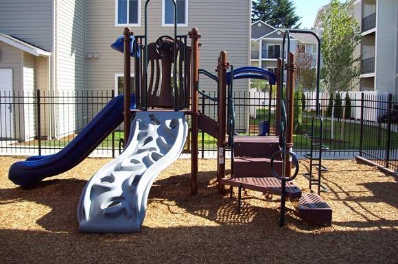 a playground with a slide  and a chair