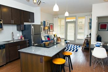Open Concept Kitchens with Granite Countertops and Tiled Backsplash