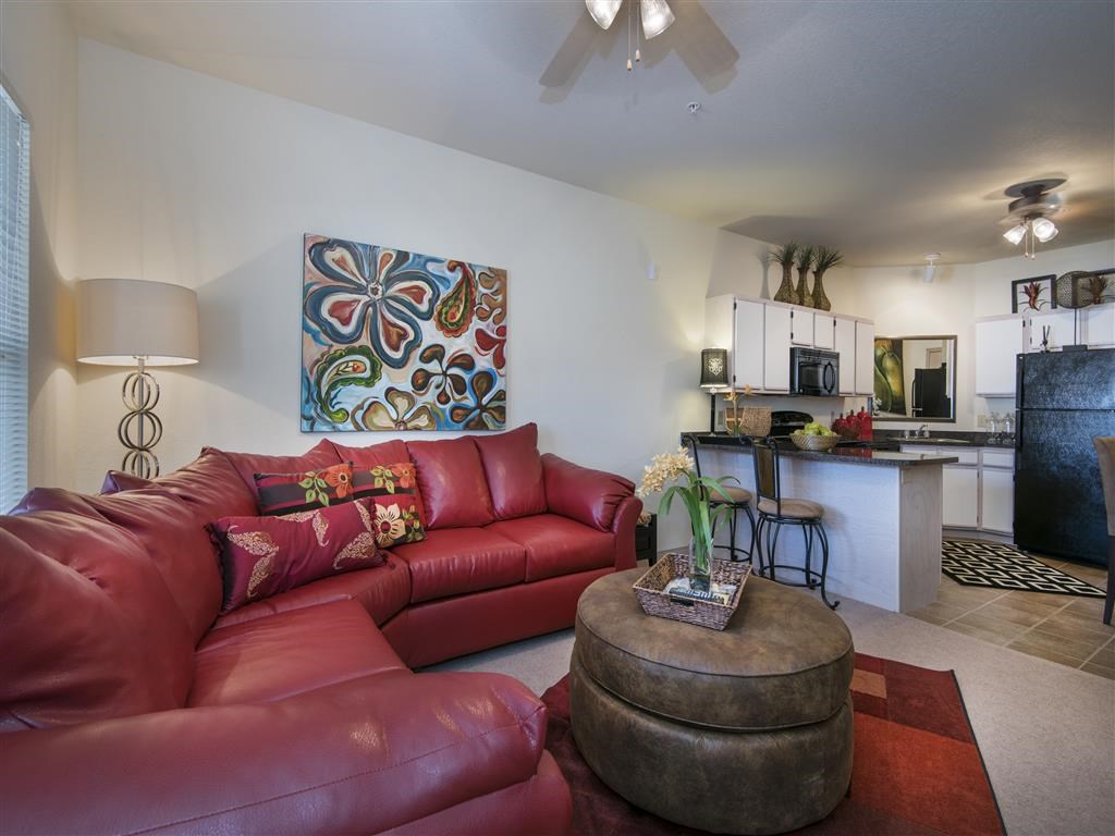 a living room with a red couch and a table