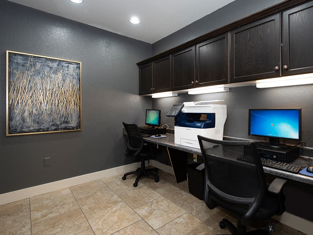 a home office with a desk and two computer monitors