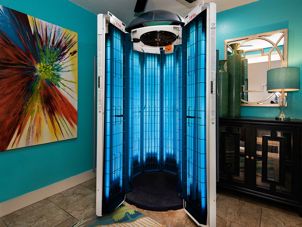 a bathroom with a shower with a blue shower curtain