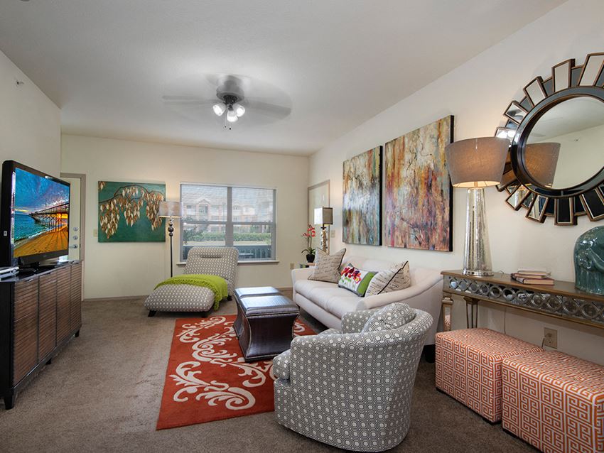 a living room with a couch and chairs and a television