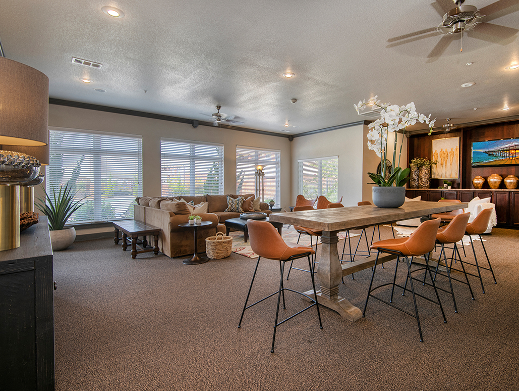a living room with a dining room table and chairs