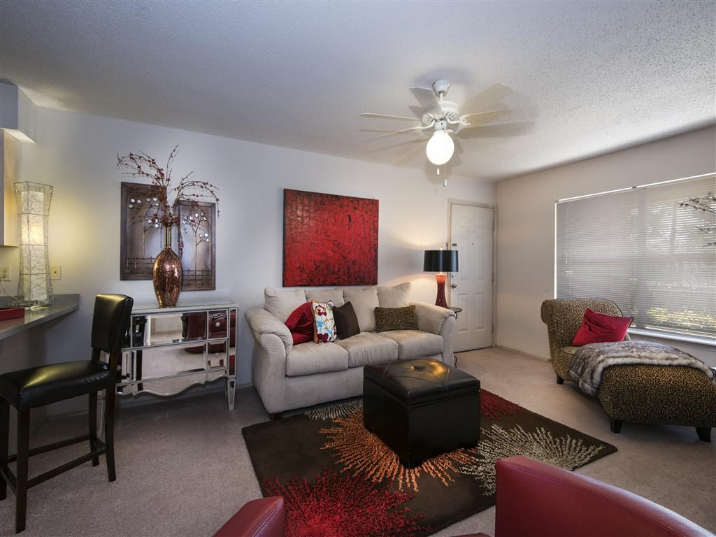 a living room with a couch and a ceiling fan