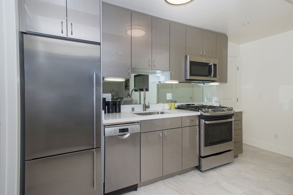 A modern kitchen with stainless steel appliances and a microwave above the stove.
