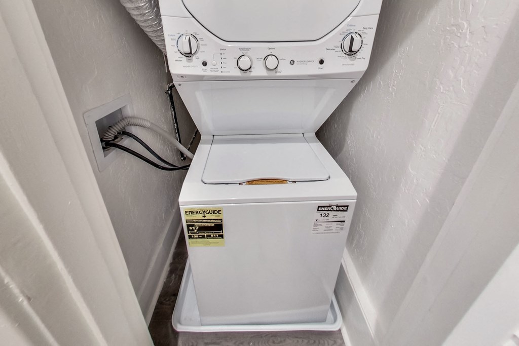 A white washing machine with a sticker on the door.