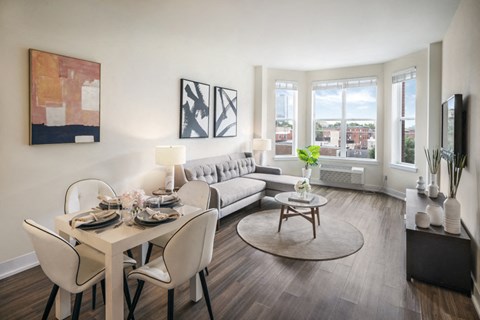 A modern dining room with a white table and chairs.