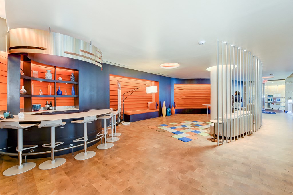 a restaurant with a bar and a lobby with stools