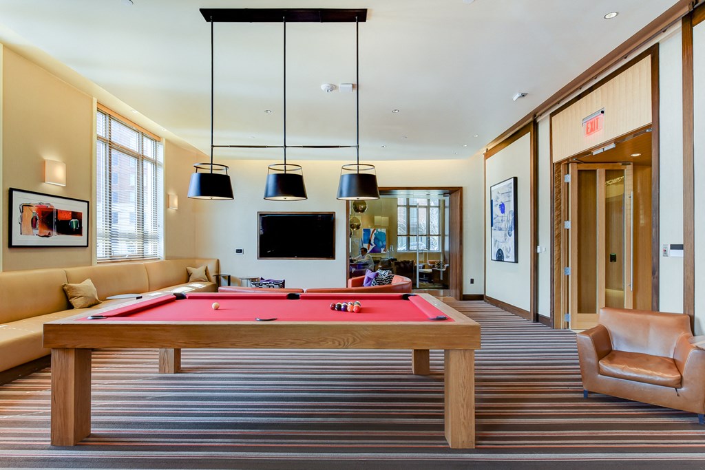 a games room with a pool table and a tv