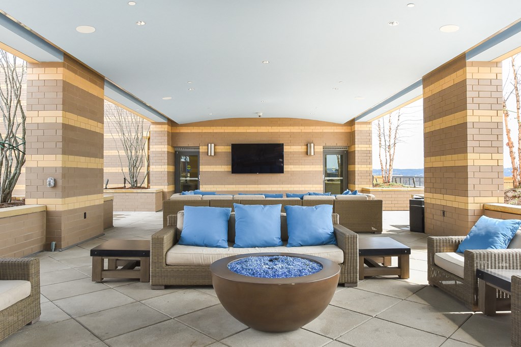 a lobby with couches and chairs and a fire pit