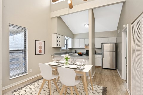 an open kitchen and dining room with a table and chairs