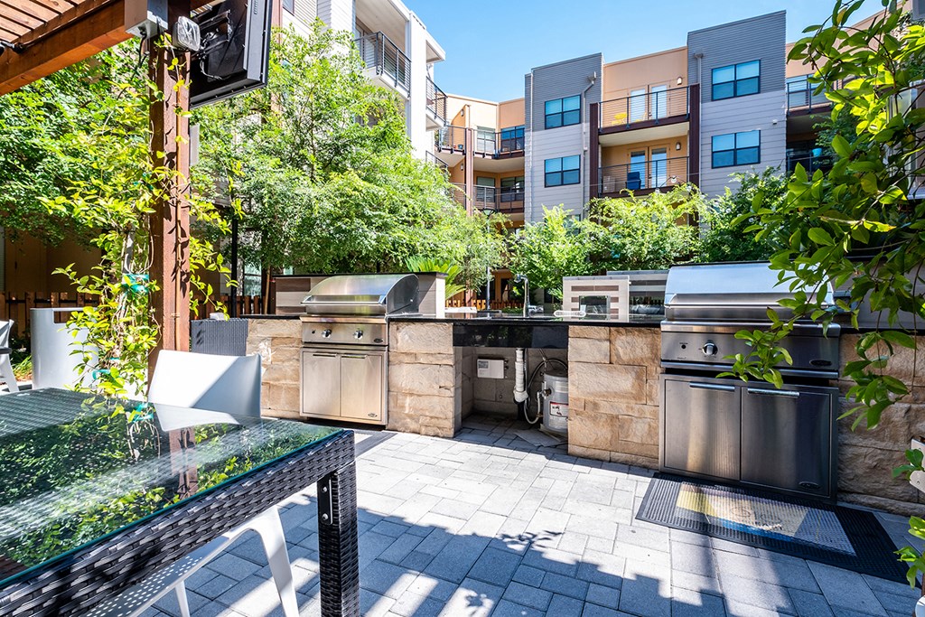 a kitchen with stainless steel appliances and a grill