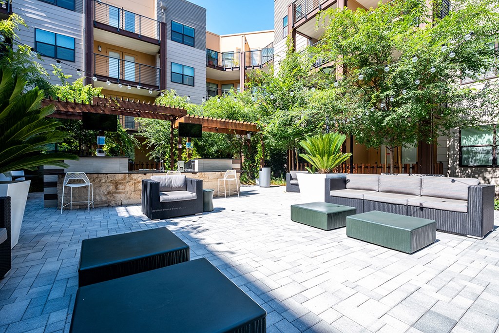 a communal area with couches and tables in a courtyard