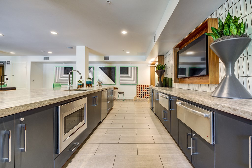 a large kitchen with stainless steel appliances and counter tops