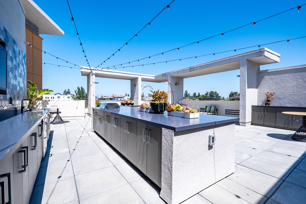 a large outdoor kitchen with a bar and a patio