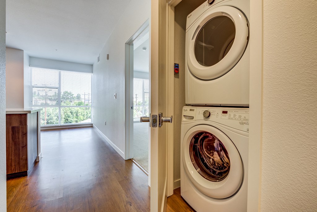 a front loading washer and dryer in a room with a door