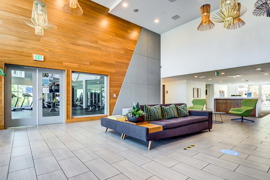 a lobby with a couch and chairs in a building