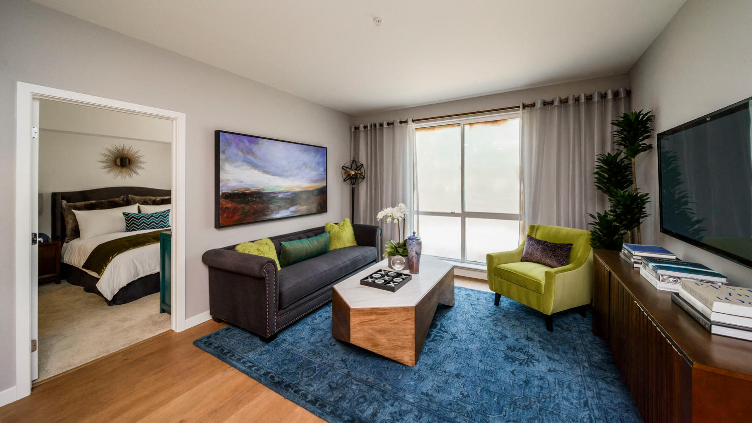 a living room with a couch and a chair and a tv