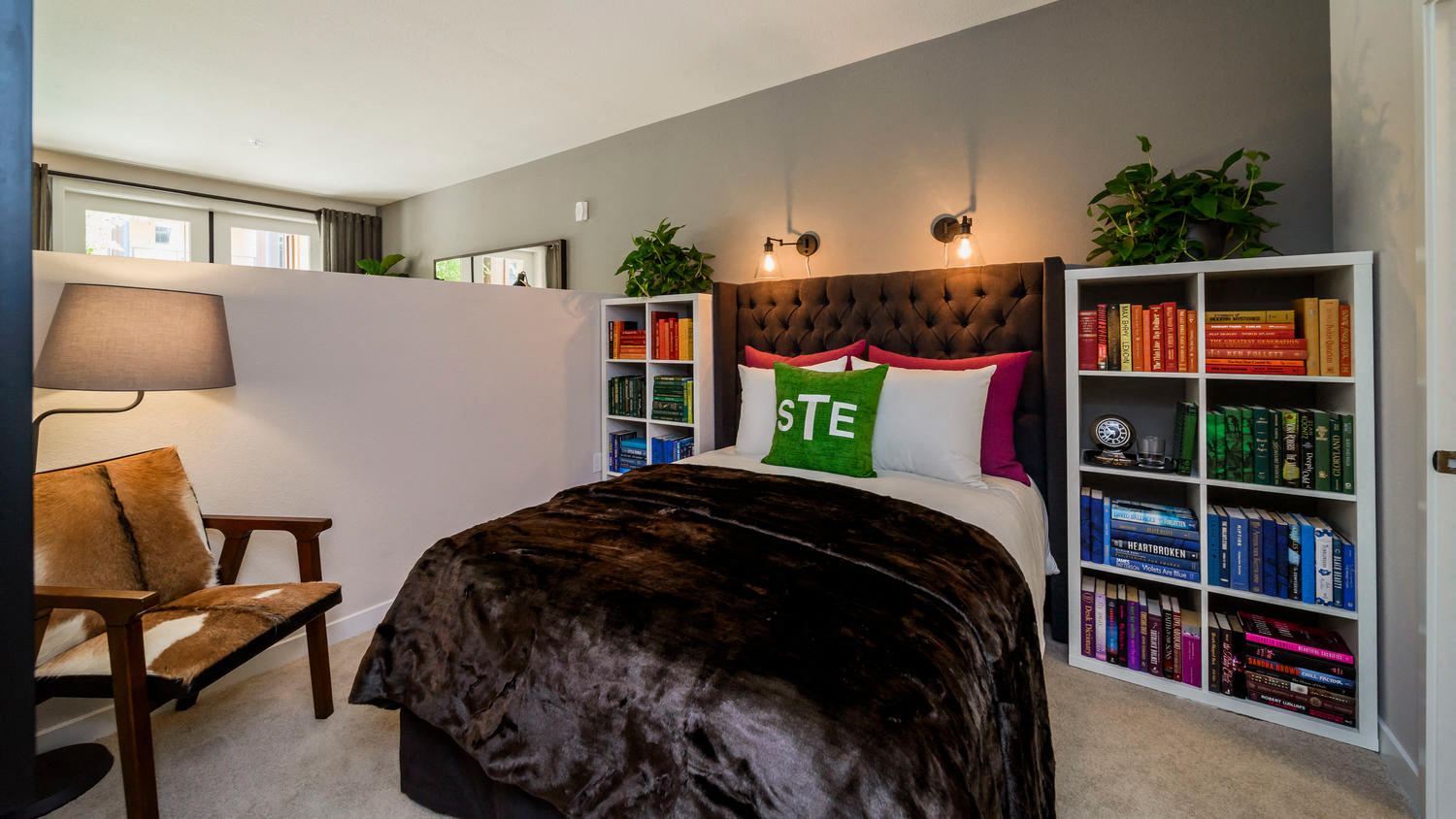 a bedroom with a bed and a bookshelf