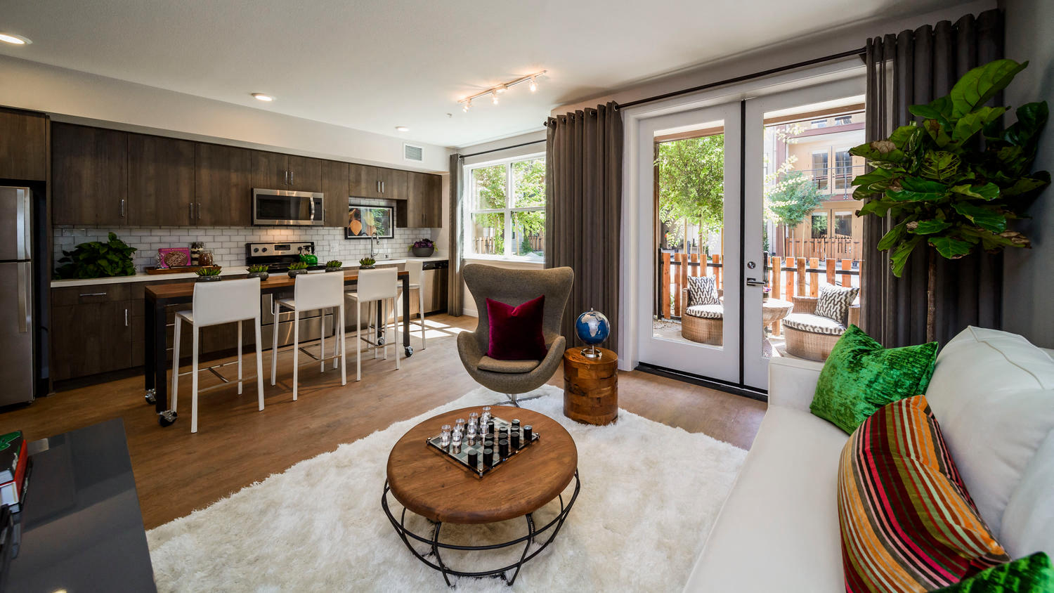 a living room and kitchen with a couch and a table