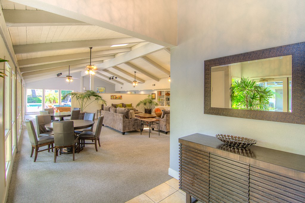 the dining room and living room of a house with a table and chairs