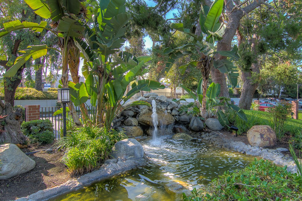 a garden with a waterfall and a pond