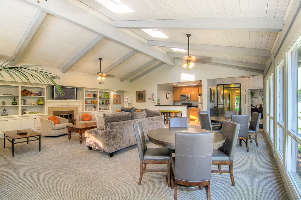 a living room with couches and chairs and a dining table