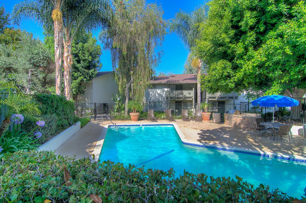 a swimming pool with a house in the background