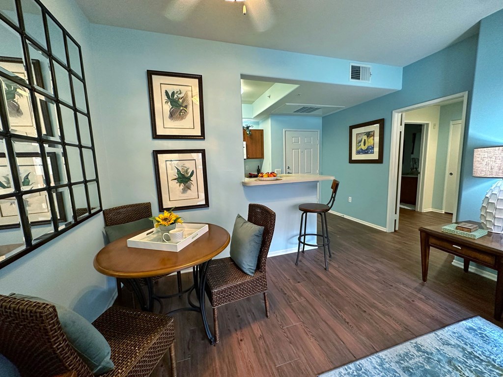 a living room with a dining room table and a kitchen