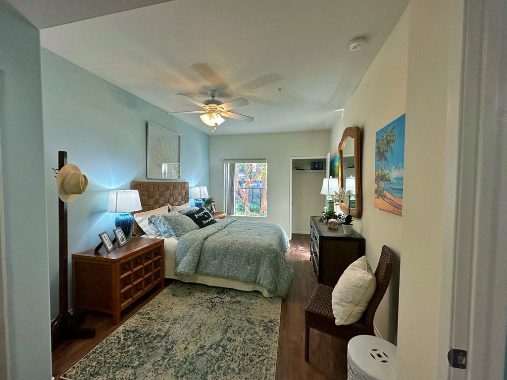 a bedroom with a large bed and a ceiling fan