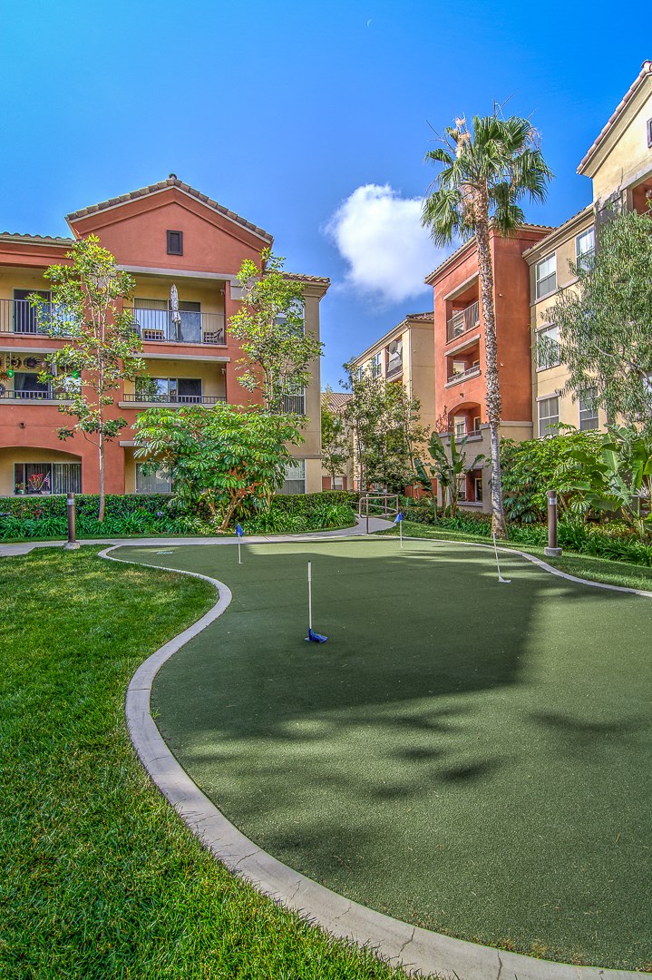 a mini golf court in front of some apartment buildings